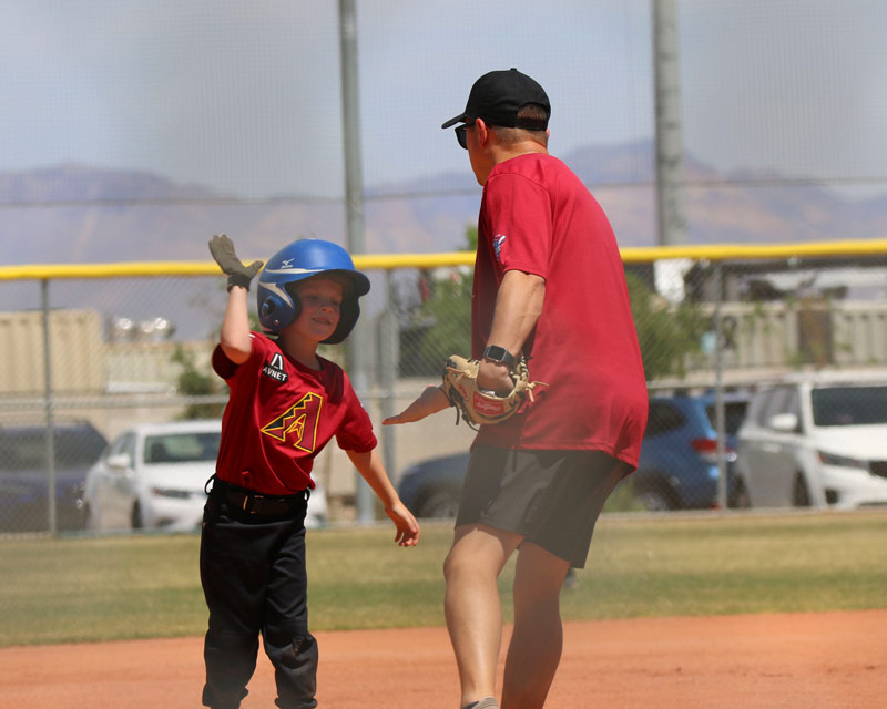 kid-coach-high-five kid-batting-and-pitching
