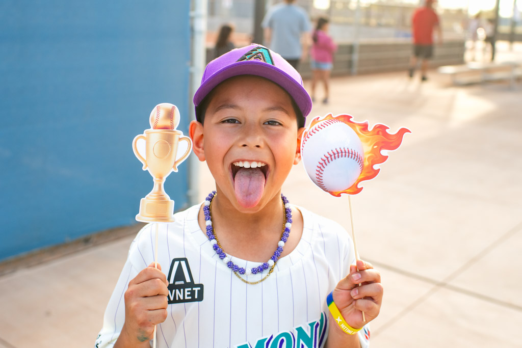 kids in dugout smiling and having fun